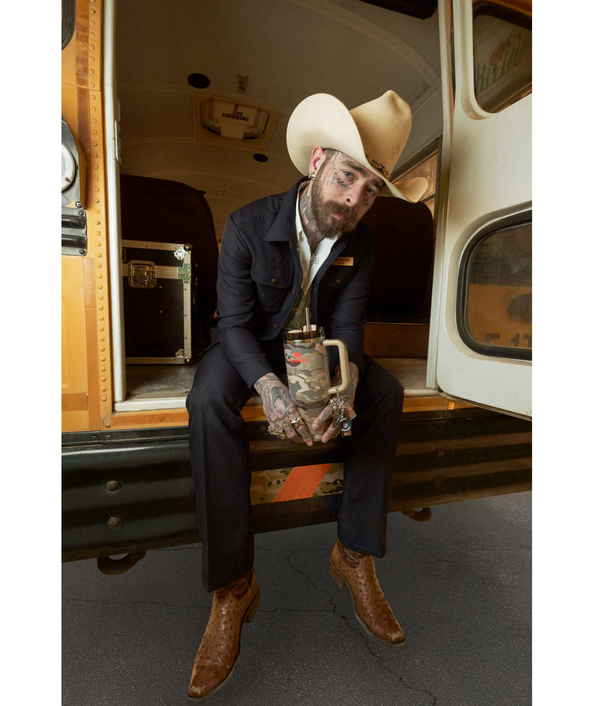 Post Malone In Vintage Tour Bus Holding A Stanley Tumbler